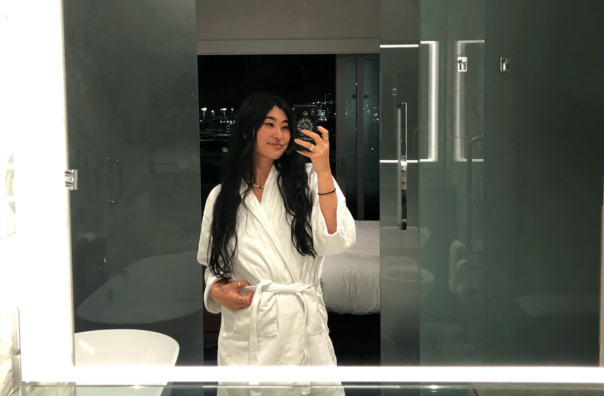 Woman takes a mirror selfie in a room at the Hilton Auckland