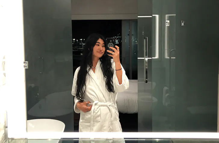 Woman takes a mirror selfie in a room at the Hilton Auckland