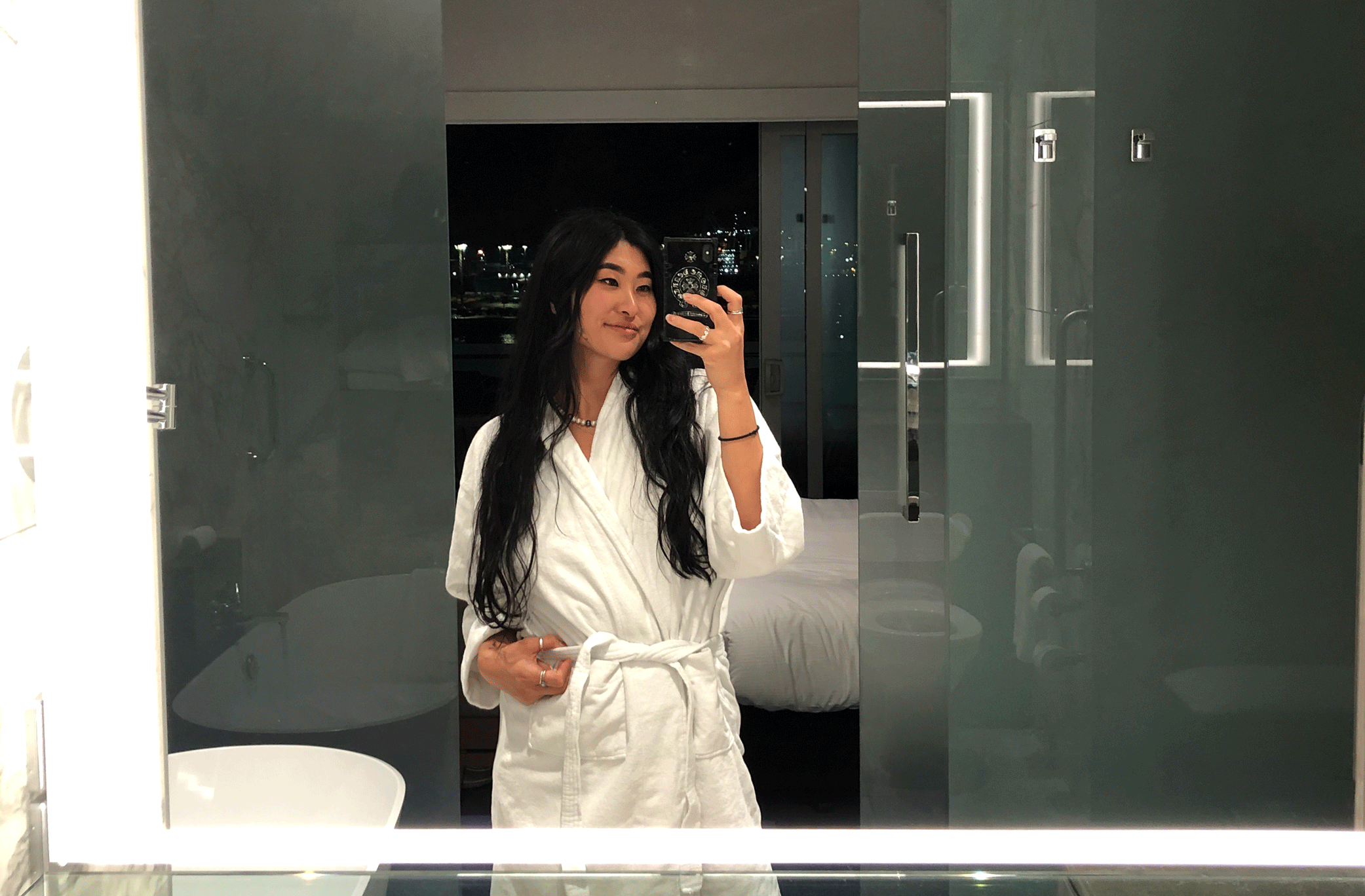 Woman takes a mirror selfie in a room at the Hilton Auckland