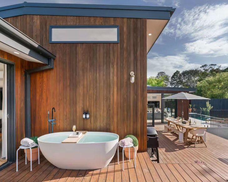 The white outdoor bath at Hiraeth Airbnb one of the best places in Victoria with an outdoor bath and spa