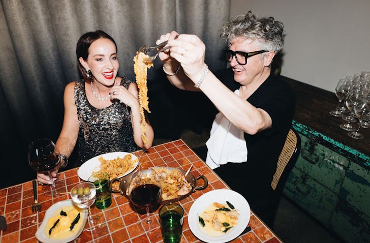 Two people have fun with pasta. 