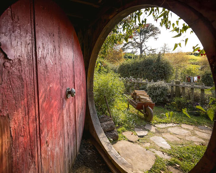A view from within a hobbit hole at Hobbiton, one of the best day trips from Auckland when you don't have a car.