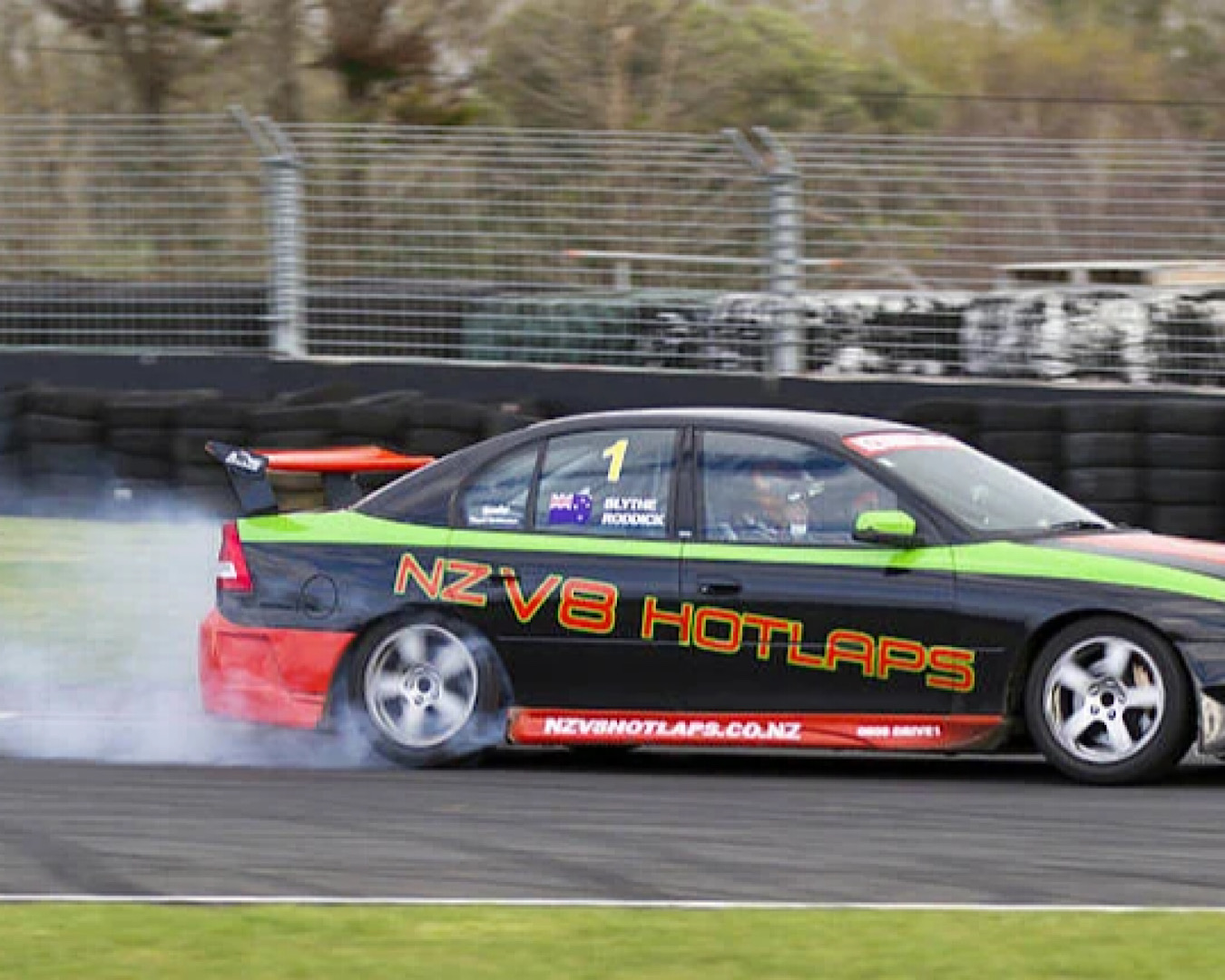A stoked dad hoons around a race track in a Holden V8 Commodore, gloating about having received the perfect Father’s Day gift.  