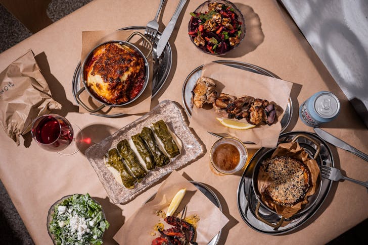 A table of Greek-inspired dishes and local beers at Homer Rogue Taverna, Cronulla
