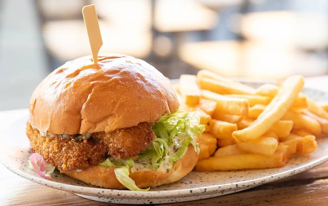 A burger and chips at a fish and chips Melbourne restaurant. 