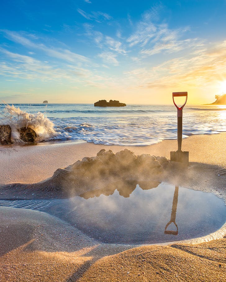 A spade dug in the sand at Hot Water Beach