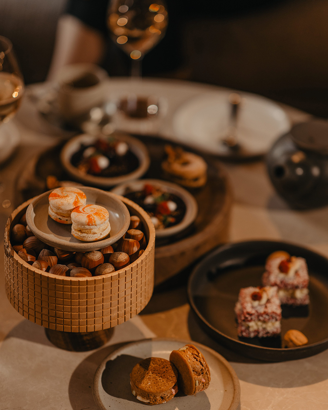 A veritable feast on the table with wine in the background at The Hotel Britomart's new high tea in Auckland.