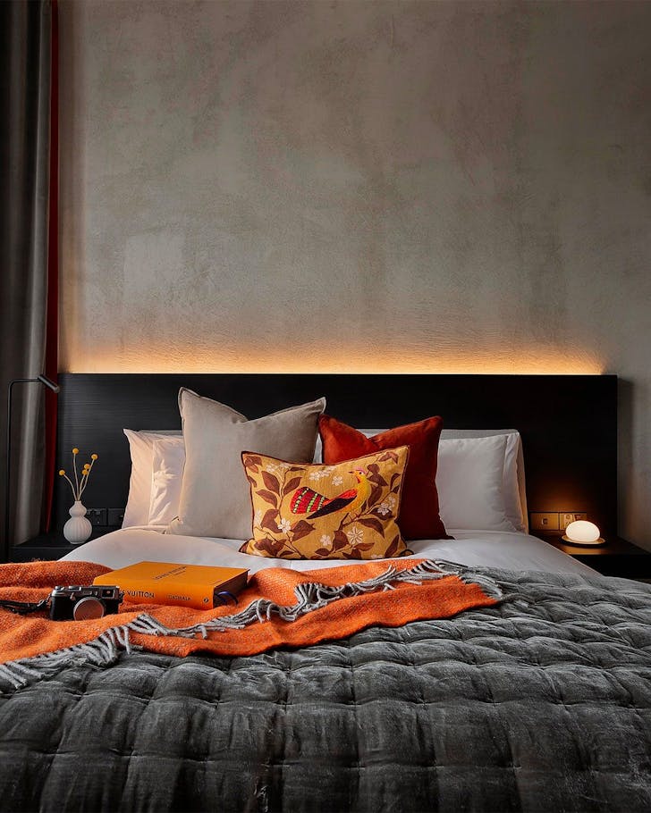 An inviting bed backlit at Hotel Fitzroy, one of the best hotels in Ponsonby.