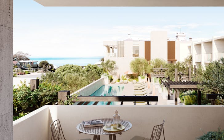 A balcony overlooking a pool inside a hotel. 
