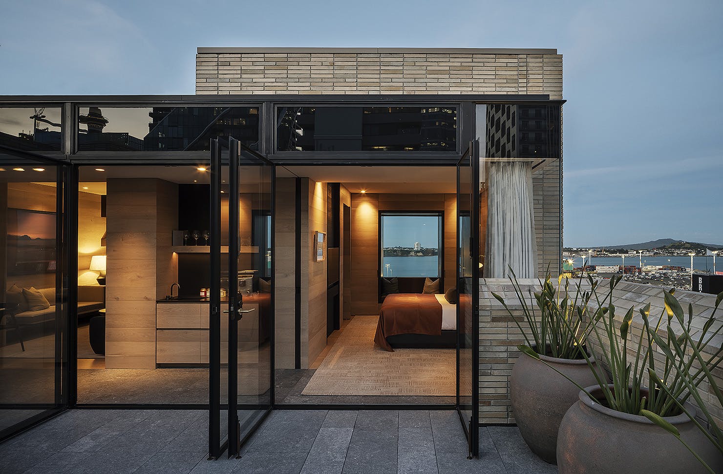 A room looks out at Rangitoto at dusk.