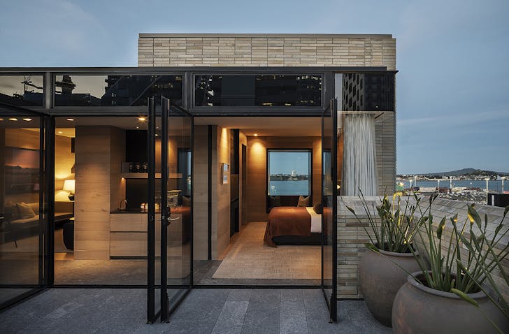 A room looks out at Rangitoto at dusk.