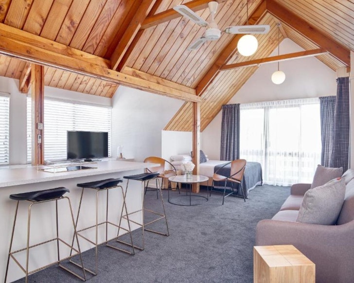 A room with wooden beams at Hotel Carlton Mill one of the best accommodation options Christchurch