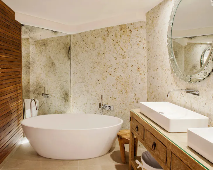 A marble bathtub in the expansive bathroom at Hotel Claris Grand Luxe in Barcelona.