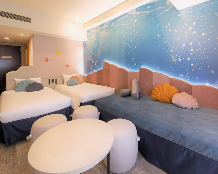 An underwater themed room with shell pillows and an ocean mural at Hotel Keihan Universal Tower.