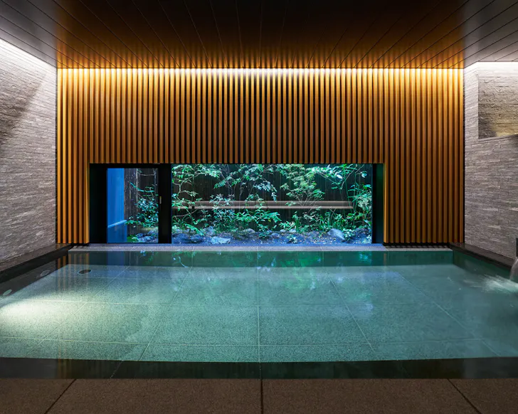 The indoor pool with garden views at Hotel Resol Trinity Osaka.