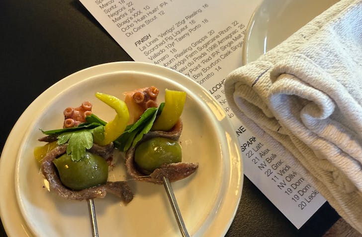 Sardines and olives on plate.