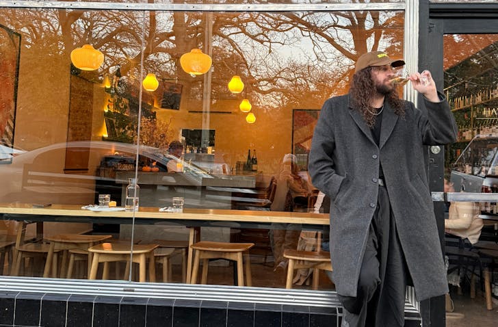 Man standing in front of bar.