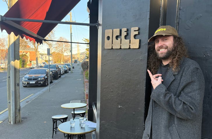 Man standing outside bar.