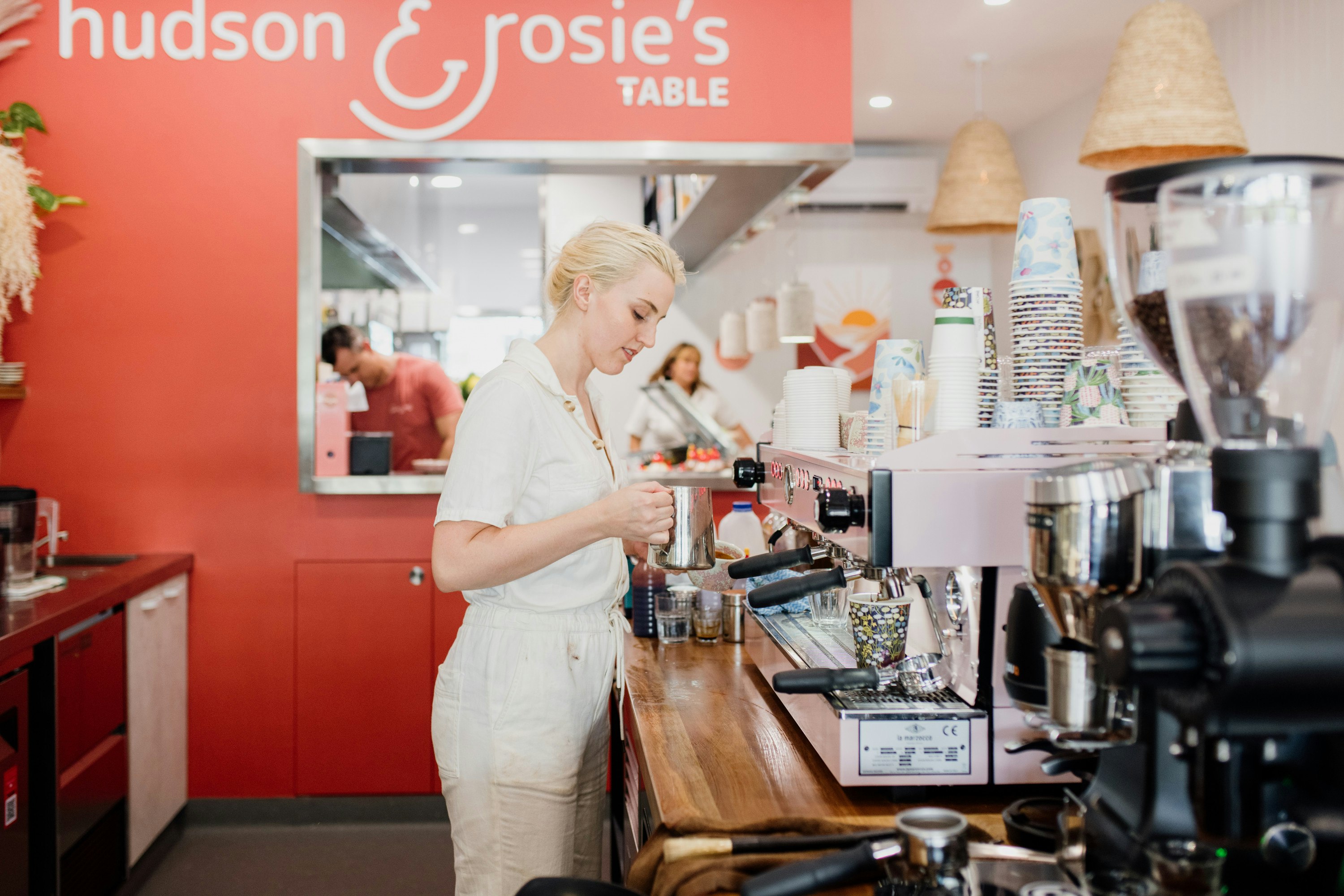 a barista standing at a coffee counter