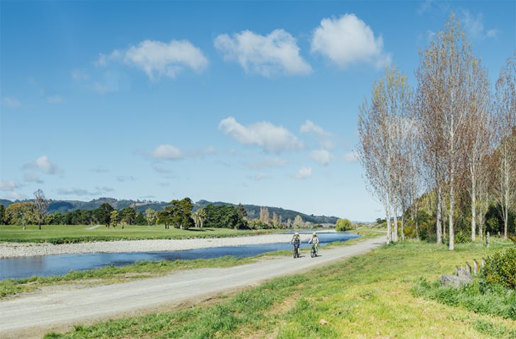The Hutt River Trail with two people cycling in pure idyllic weather.
