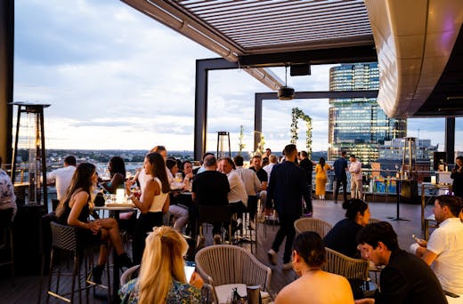People drinking at the Hyatt Regency rooftop bar