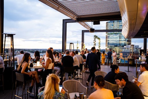 People drinking at the Hyatt Regency rooftop bar