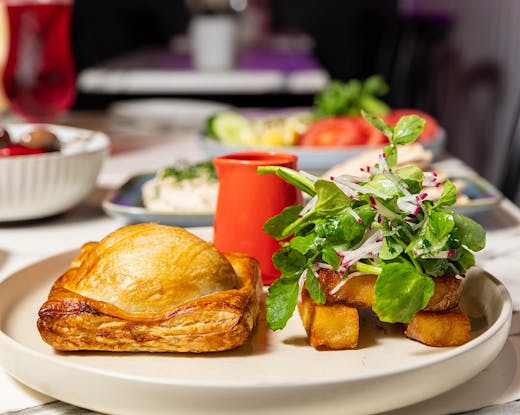 Vegan beef wellington served with a side salad