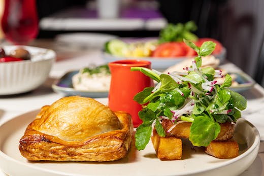 Vegan beef wellington served with a side salad