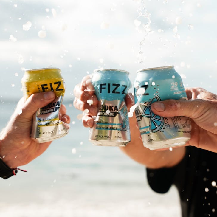 Hard Fizz cans being held and shaken 