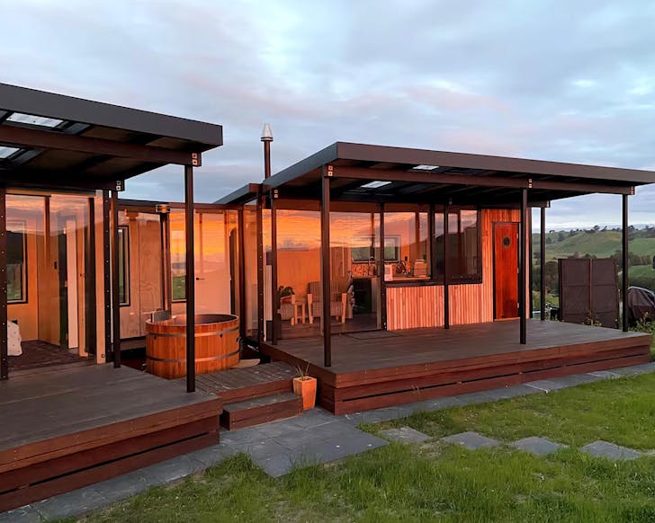 Two quaint units covered in orange sunset.