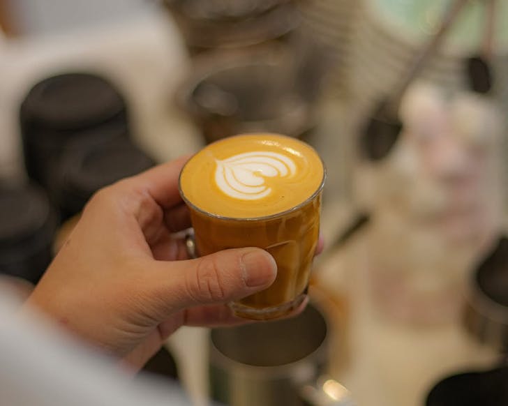 A short milk coffee in a glass cup from RAD Cafe.