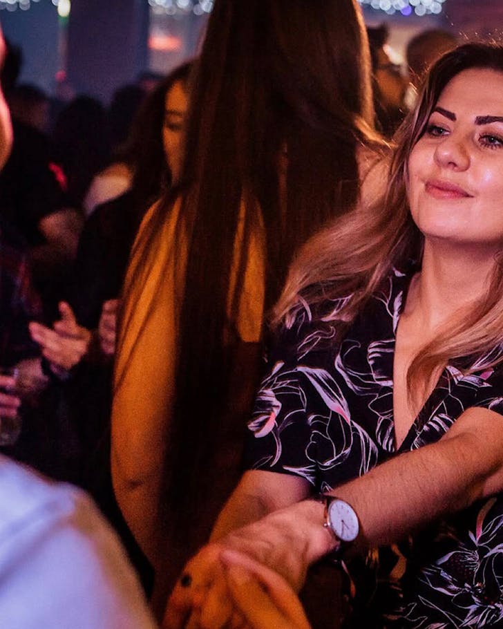 People dance at a Latin Club night.