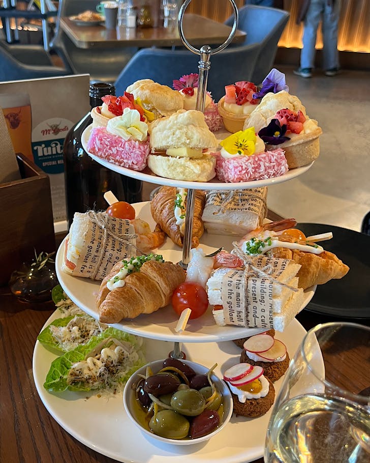 A three-tiered high tea stand with all the delectable goodies from Tuitui Museum Bistro and Cafe in Auckland