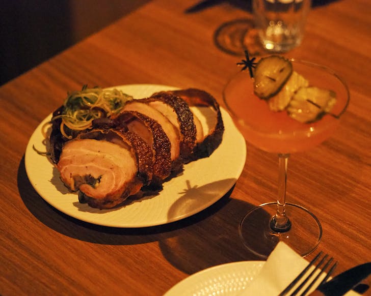 Lechon pork and a pickletini sitting pretty at Bar Magda