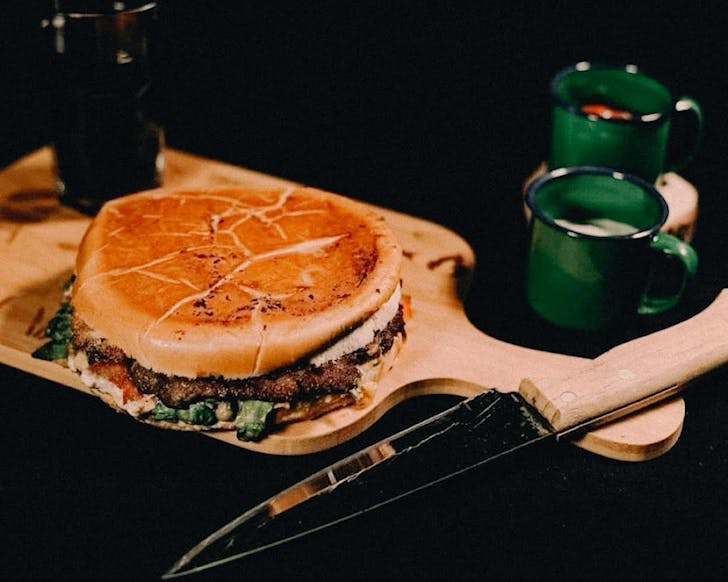 A Xis GaÃºcho Brazilian style burger with meat and vegetable fillings