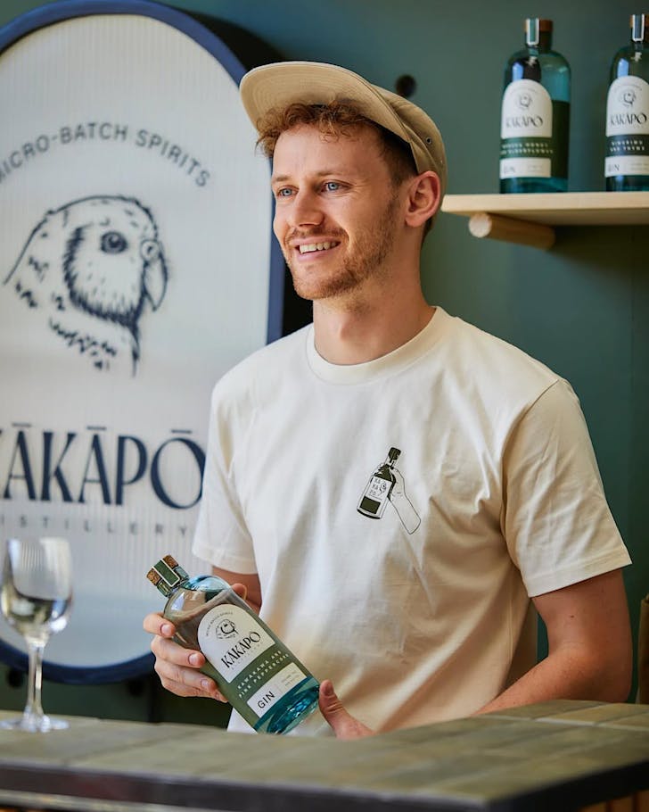 KÄkÄpÅ Gin Distiller Conrad holds a bottle of their recently rebranded gin bottles