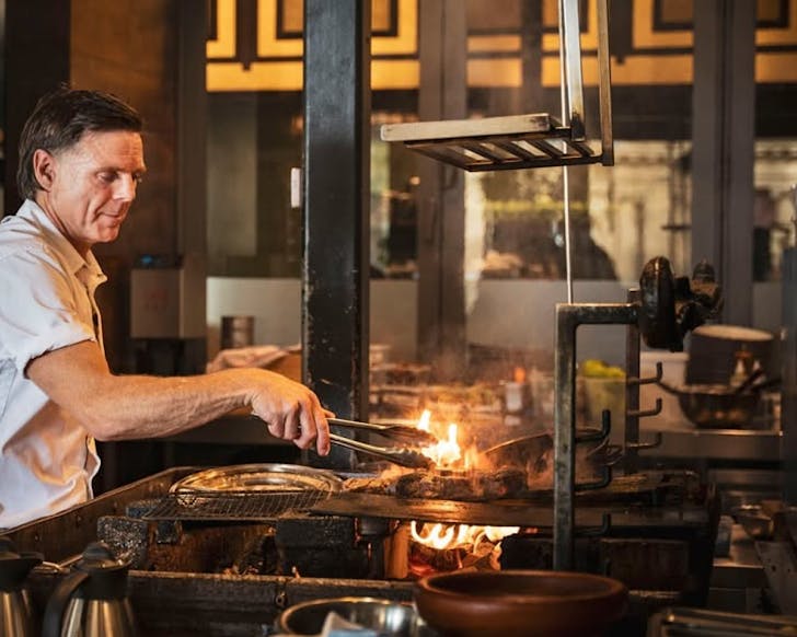 Chef Ben Bayly working with fire at Ahi