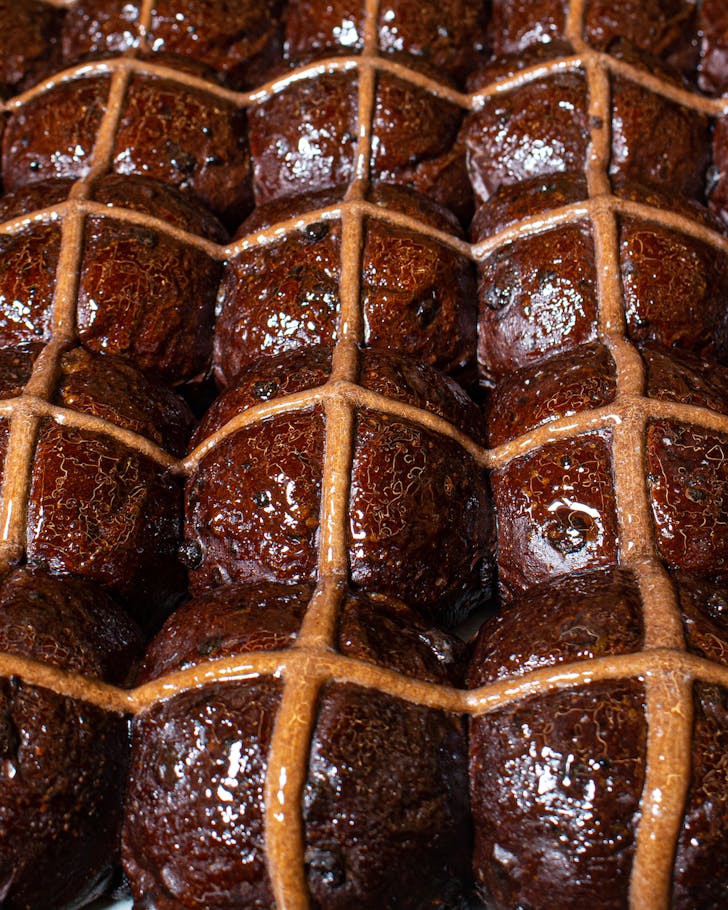shiny chocolate hot cross buns in a baking tray at sydney bakery black star pastry