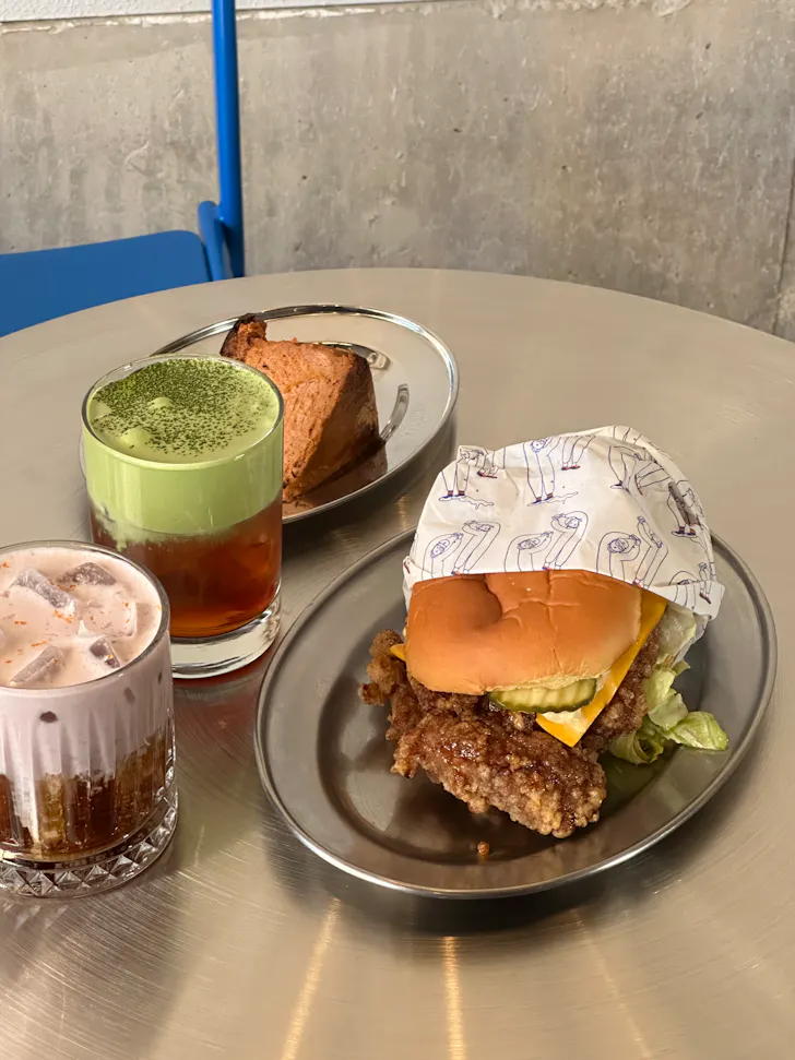 Burger and speciality coffee and matcha displayed at SANDWHICH in Sydney
