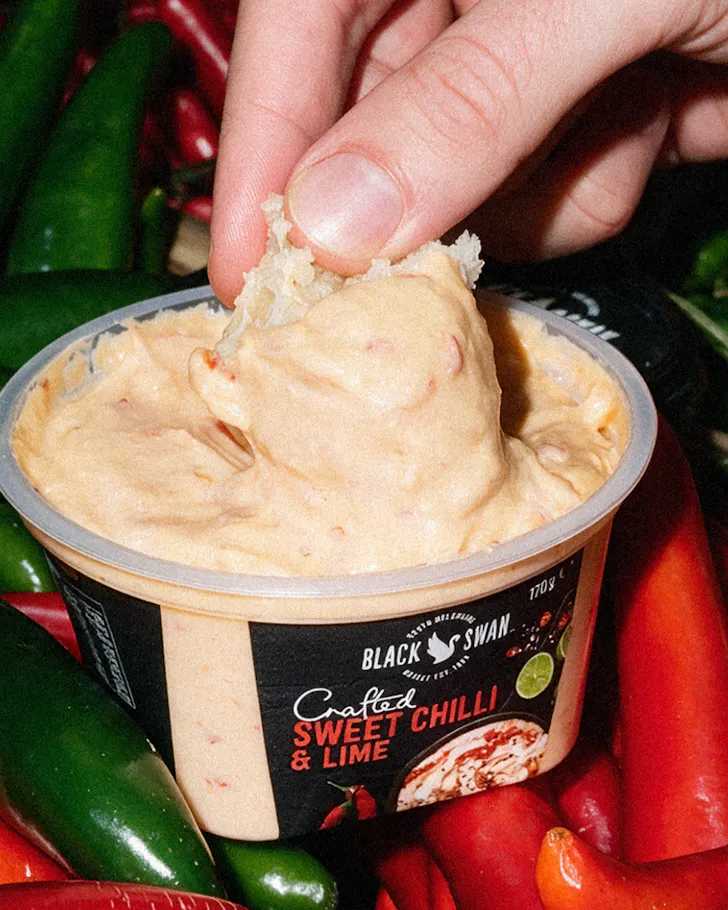 Hand dipping green dip