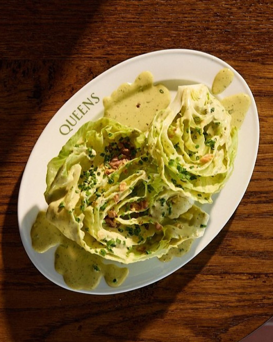 Iceberg wedge topped with walnuts and slathered in green goddess dressing. 