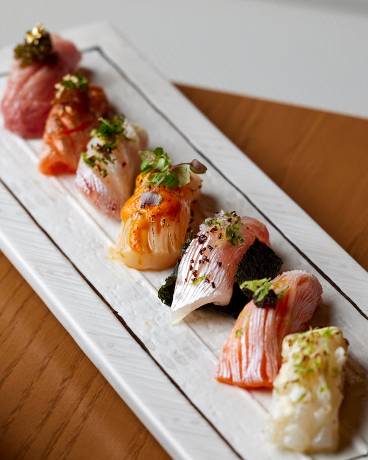 A plate of beautifully styled sashimi at a fine dining restaurant.