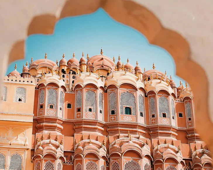 A beautiful, pastel pink sculptural temple in India. 