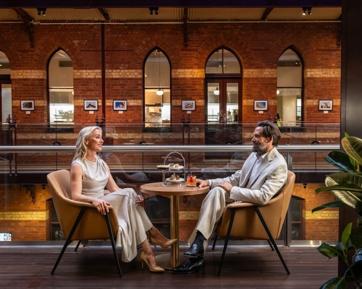 A couple has tea at InterContinental Melbourne one of the best hotels for the British and Irish Lions Tour