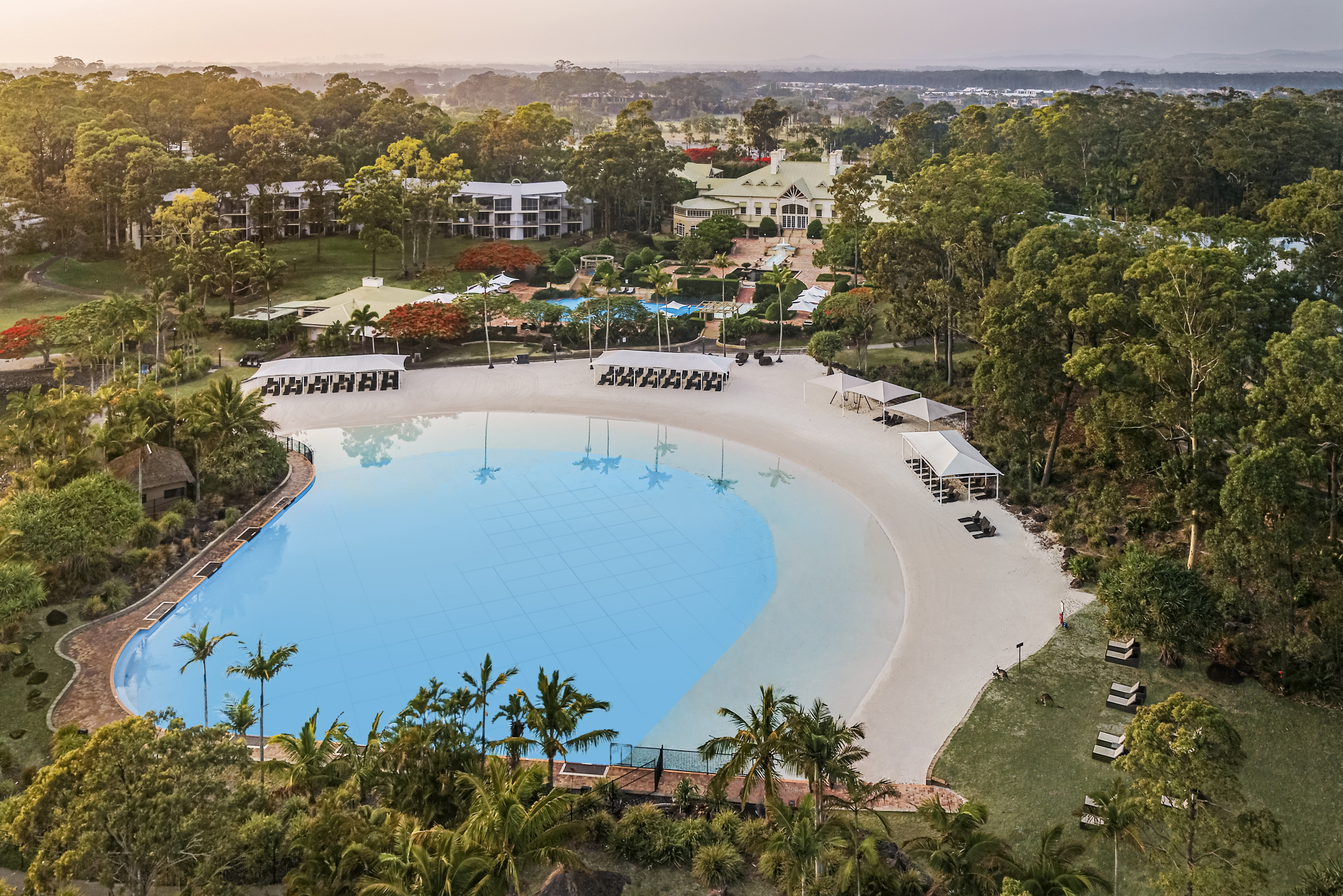 a drone shot of a lagoon beach at the intercontinental sanctuary cove