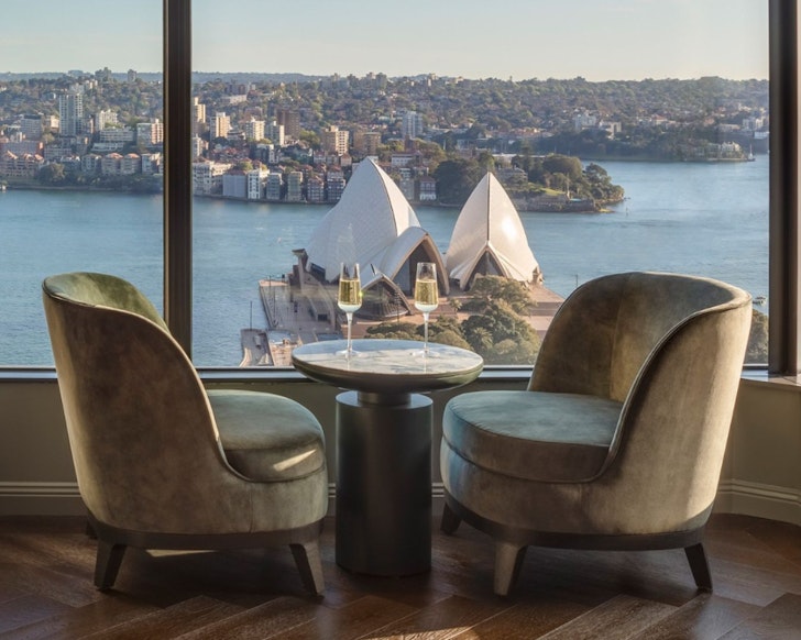 A table with two champagne glasses overlooking the opera house at InterContinental Sydney one of the best hotels British and Irish Lions Tour