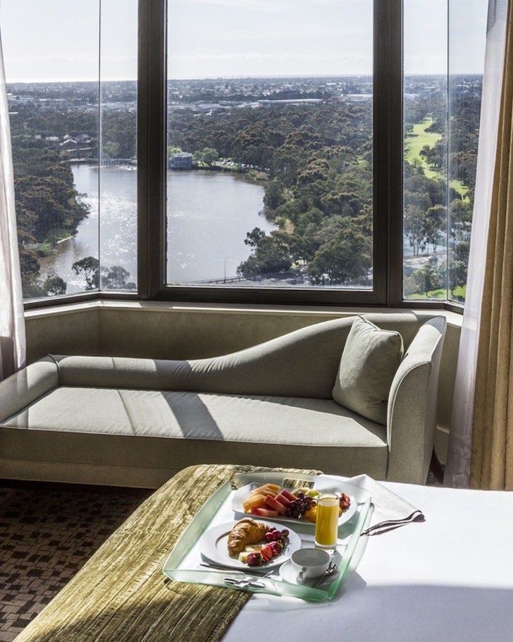 Breakfast on a bed with a view of the river at Intercontinental Adelaide one of the best Adelaide hotels