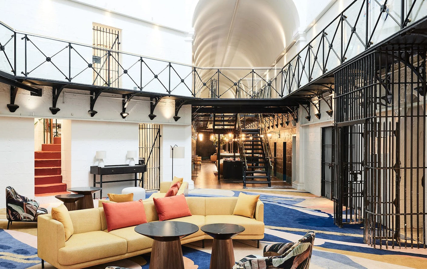 A former prison converted boutique hotel with couches.