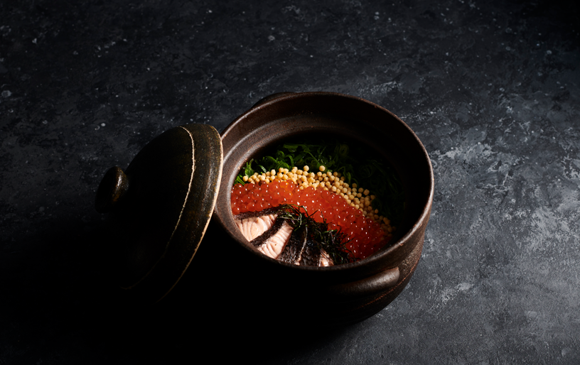 A single dish with fish roe on a black table at a best japanese Melbourne restaurant.