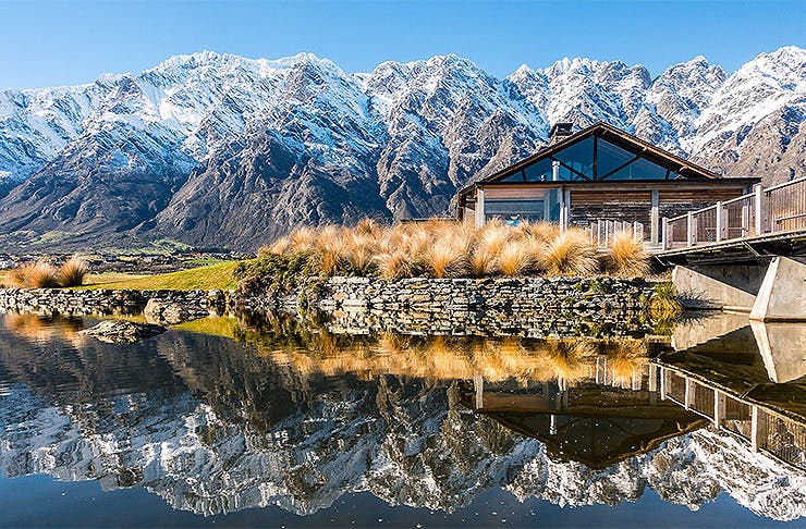 The outside of the clubhouse at Jack's Point shows the stunning Remarkables in the background.